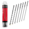 A set of SDS-Plus drill bits in a clear plastic tube packaging, with the drill bits arranged diagonally next to the packaging. Anteprima dell’immagine prodotto