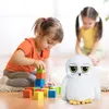 Two young girls are playing with building blocks and a stuffed owl toy in a room. Produktbild-Vorschau