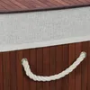 A close-up view of the side of a bamboo laundry basket, showing the texture of the wood and a rope handle. Produktbild-Vorschau