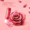 A Vaseline lip balm, a rose, and a pair of lips are arranged on a pink background with rose petals scattered around. Produktbild-Vorschau