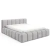 A modern upholstered bed frame with a mattress on a white background. Produktbild-Vorschau