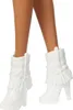 Close-up of a doll's legs wearing white cowboy boots. Produktbild-Vorschau