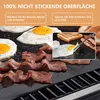 A close-up view of bacon and eggs cooking on a grill mat, with an inset image showing a close-up of an egg being flipped. Produktbild-Vorschau