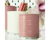 Several desk organizers holding pencils and pens, with a flower in the background. Voir les images du produit