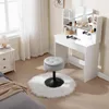 A vanity table with a stool and a fluffy rug in a bedroom setting. Produktbild-Vorschau