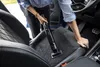 A person is vacuuming the interior of a car. Náhled obrázku produktu