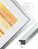 A close-up view of a silver picture frame with a mat and a sample artwork, along with a cross-section of the frame profile showing dimensions. Produktbild-Vorschau