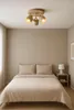 A bedroom scene with a bed, nightstand, and ceiling light. Produktbild-Vorschau
