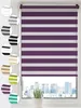 A purple and white striped roller blind is shown hanging in a window, with a cityscape visible outside. Several circular swatches of different colored blinds are displayed to the left of the main product. Produktbild-Vorschau