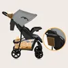A side view of a stroller with highlighted features. Podgląd zdjęcia produktu