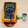 A digital multimeter is connected to two 9V batteries. Produktbild-Vorschau