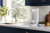 A modern kitchen counter with a water carbonator, sink, faucet, and some decorative items. Produktbild-Vorschau