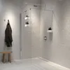 A modern bathroom with a walk-in shower, featuring a shower shelf. Produktbild-Vorschau
