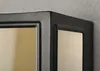 Close-up of the corner of a black outdoor light fixture with a gold-colored glass panel. Produktbild-Vorschau
