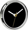 A close-up, angled view of a modern clock with a black face and silver and gold accents. Anteprima dell’immagine prodotto