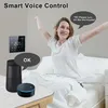 A woman is waking up in bed and stretching, while a smart thermostat and smart speaker are visible on a table. Produktbild-Vorschau