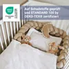 A crib with bedding, stuffed animals, and a braided bumper. Produktbild-Vorschau