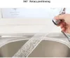 A hand holding a faucet extender over a sink, with water spraying out. Produktbild-Vorschau