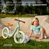 A child is sitting next to a balance bike in a skate park. Náhľad obrázku produktu