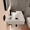 A modern bathroom sink with a black faucet. Produktbild-Vorschau