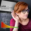 A woman is holding her hand to her ear, listening, with a graphic showing sound levels and icons below a kitchen hood. Produktbild-Vorschau
