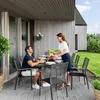 A couple is enjoying a meal at a table on a patio. Náhled obrázku produktu