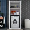 A white cabinet with a washing machine inside, placed in a bathroom with blue tiled walls and a geometric patterned wall. Produktbild-Vorschau