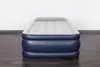 An inflatable air mattress is shown on a wooden floor against a white wall. Náhled obrázku produktu