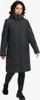 A woman is standing and modeling a black winter jacket. Produktbild-Vorschau