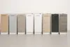 A row of kitchen base cabinets with different finishes and handles, displayed against a plain wall and floor. Produktbild-Vorschau