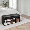 A shoe bench with storage is placed next to a bed in a bedroom. Produktbild-Vorschau
