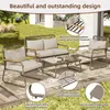 An outdoor patio set with a sofa, two chairs, and a coffee table, set on a wooden deck with grass and a building in the background. Podgląd zdjęcia produktu