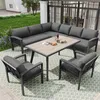 An outdoor patio set with a sectional sofa, a table, and two chairs on a patterned rug. Produktbild-Vorschau