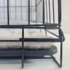 A close-up view of the corner of a dog crate with a gray mat inside. Produktbild-Vorschau