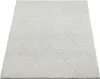 A close-up, angled view of a shaggy rug with a diamond pattern. Produktbild-Vorschau