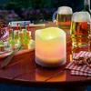 An outdoor table setting with a solar candle, beer mugs, and appetizers. Produktbild-Vorschau