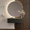 A modern hallway with a round illuminated mirror, a floating console, and a decorative vase with dried flowers. Produktbild-Vorschau