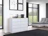 A modern living room with a white dresser, a sectional sofa, and large windows overlooking a garden. Produktbild-Vorschau