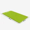 A bright green yoga mat is shown from a diagonal angle, with dimensions indicated. Produktbild-Vorschau