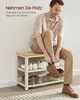 A man is sitting on a shoe bench and putting on his shoes. The shoe bench has two shelves with shoes on them. Produktbild-Vorschau