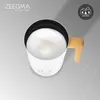 A white milk frother with a wooden handle sits on a marble-like surface. Produktbild-Vorschau