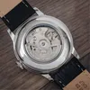 The back of a watch with its mechanical movement visible. Produktbild-Vorschau