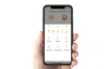 A hand holding a smartphone displaying the Yeelight Smart LED Bulb app interface. Náhled obrázku produktu