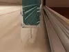 Close-up view of a shower door seal and track. Produktbild-Vorschau