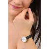 A woman's hand touching her face, wearing a watch. Produktbild-Vorschau