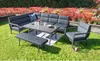 An outdoor furniture set arranged on a lawn with a flower bed in the background. Produktbild-Vorschau
