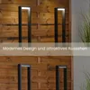 Two modern black bollard lights are shown against a wooden slatted fence. The top image has a text overlay. Anteprima dell’immagine prodotto