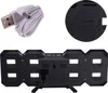 The image shows the back of a digital clock and its accessories. Produktbild-Vorschau