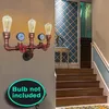 A steampunk-style wall lamp with gauges and red valves is mounted on a wall next to a staircase. Náhled obrázku produktu