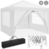 A white pop-up gazebo is shown from a slightly elevated, diagonal angle. The gazebo is open on one side, revealing the interior. In the foreground, to the left, is a black carrying bag for the gazebo, and to the right is the folded frame of the gazebo. Voir les images du produit